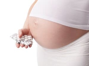 Pregnant woman with pills