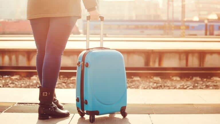 I Don't Know Where My Spouse Lives - Woman standing with rolling suitcase