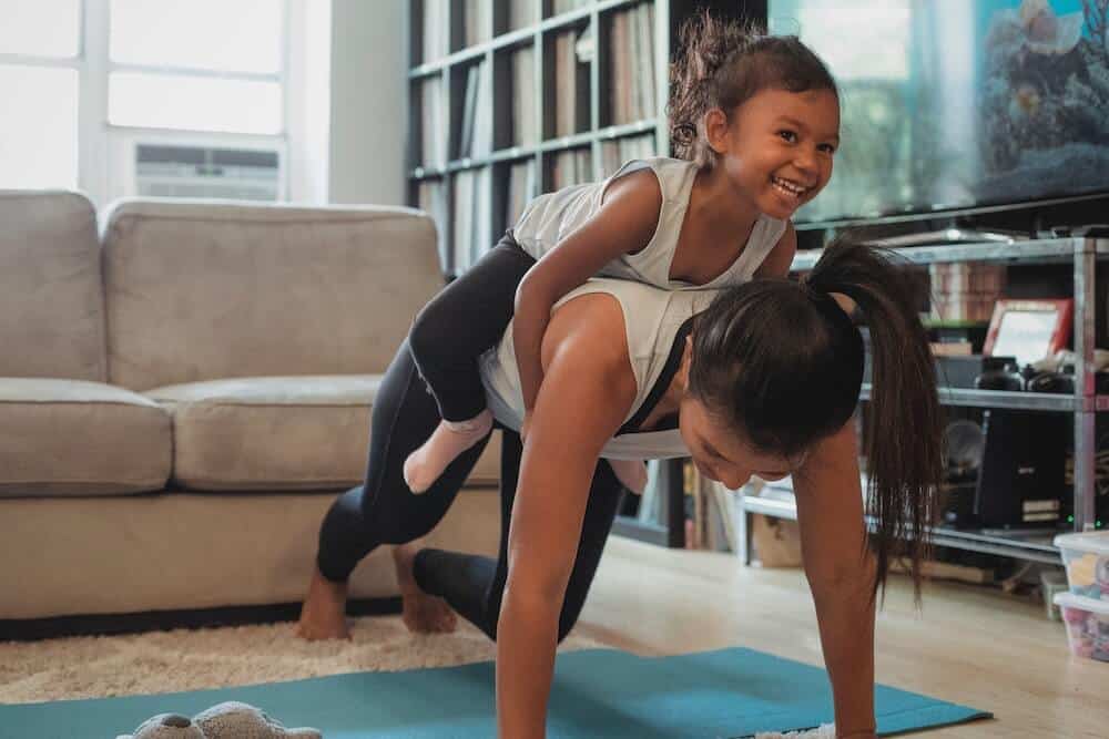 mother and daughter doing yoga - Geographic Restrictions in Texas and the Risk of Losing Access to Children in Divorces and Child Custody Cases