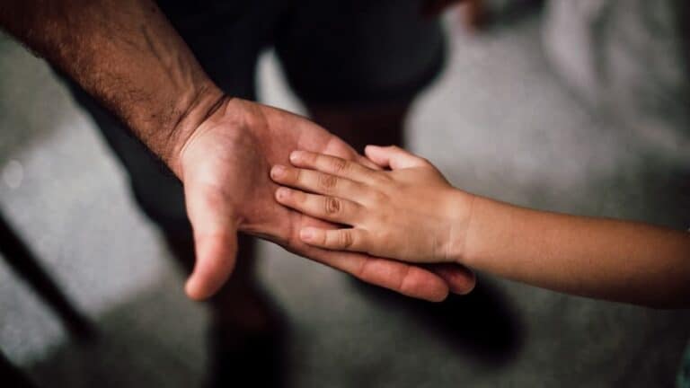 Childs hand in fathers hand